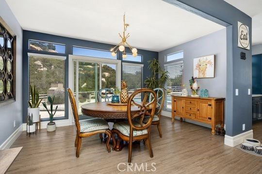41350 Calle Bandido, Murrieta, CA 92562 - dining area featuring a chandelier, wood finished floors, and baseboards