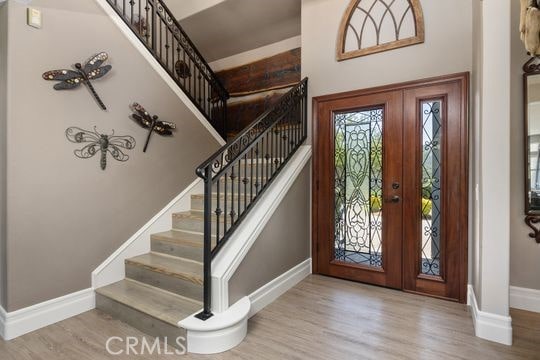 41350 Calle Bandido, Murrieta, CA 92562 - entryway featuring baseboards, wood finished floors, and stairs
