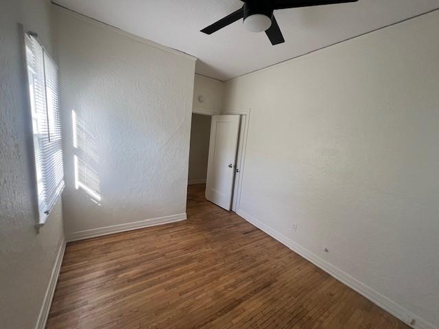 3320 E 8th St, Long Beach, CA 90804 - unfurnished room featuring baseboards, a ceiling fan, and wood finished floors