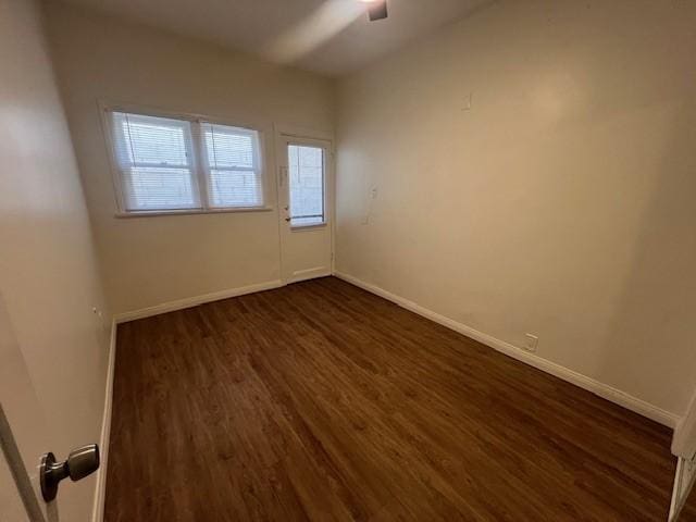 3320 E 8th St, Long Beach, CA 90804 - spare room with dark wood-style flooring, a ceiling fan, and baseboards