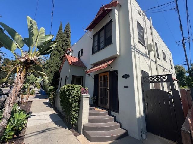 3320 E 8th St, Long Beach, CA 90804 - view of front of home with stucco siding and a gate