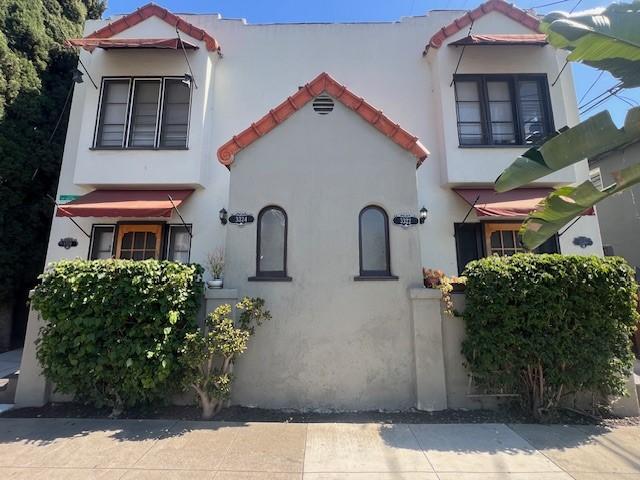 3320 E 8th St, Long Beach, CA 90804 - mediterranean / spanish-style home featuring a tiled roof and stucco siding