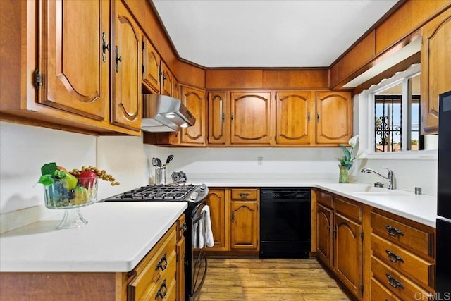 1597 Hermes St, San Diego, CA 92154 - kitchen with black appliances, under cabinet range hood, a sink, and brown cabinetry