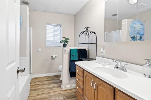 40632 Lela May Ave, Hemet, CA 92544 - full bathroom with wood finished floors, an enclosed shower, vanity, toilet, and baseboards