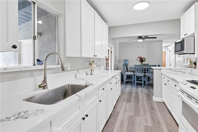 40632 Lela May Ave, Hemet, CA 92544 - kitchen featuring stainless steel microwave, a sink, ceiling fan, white range, and white cabinetry