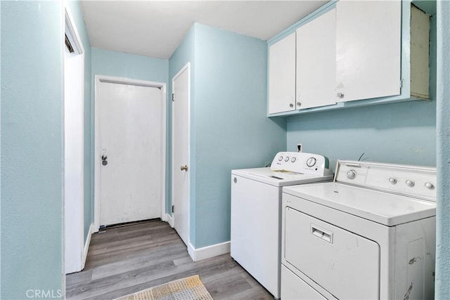 40632 Lela May Ave, Hemet, CA 92544 - washroom with cabinet space, washing machine and dryer, light wood finished floors, and baseboards