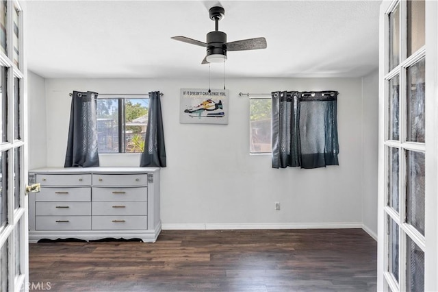40632 Lela May Ave, Hemet, CA 92544 - unfurnished bedroom with dark wood finished floors, multiple windows, and baseboards