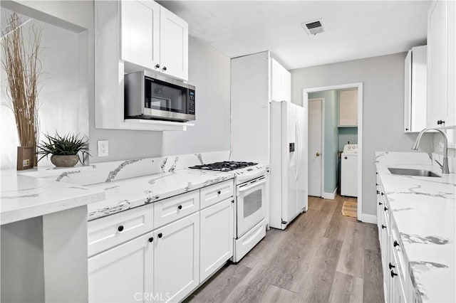 40632 Lela May Ave, Hemet, CA 92544 - kitchen with a sink, white appliances, white cabinetry, and light wood-style flooring