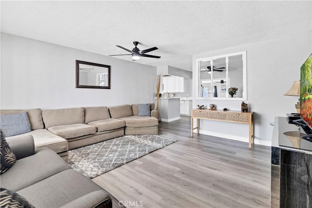 40632 Lela May Ave, Hemet, CA 92544 - living room featuring ceiling fan, wood finished floors, a textured ceiling, and baseboards