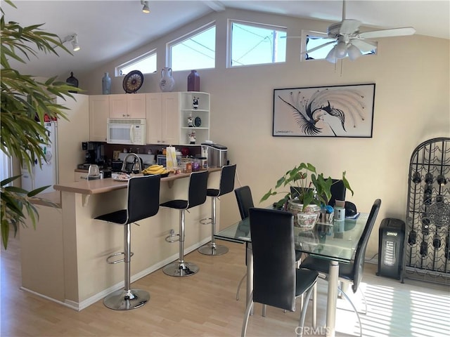 927 W 6th St, San Pedro, CA 90731 - dining room featuring light wood finished floors, vaulted ceiling, and ceiling fan