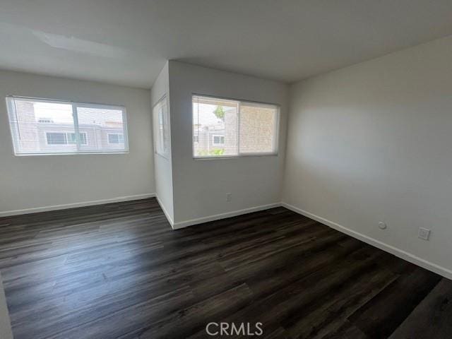 45 Golden Glen St Unit 75, Irvine, CA 92604 - spare room with plenty of natural light, baseboards, and dark wood-style floors