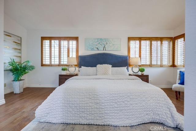 7712 Rockybrook Way, Stanton, CA 90680 - bedroom with wood finished floors, multiple windows, and baseboards
