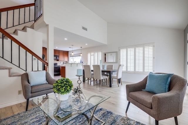 7712 Rockybrook Way, Stanton, CA 90680 - living room featuring stairway, light wood-style flooring, baseboards, high vaulted ceiling, and recessed lighting