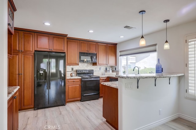 7712 Rockybrook Way, Stanton, CA 90680 - kitchen with black appliances, light wood finished floors, tasteful backsplash, brown cabinets, and recessed lighting