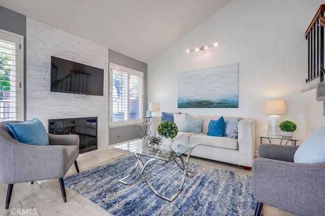 7712 Rockybrook Way, Stanton, CA 90680 - living area with lofted ceiling, wood finished floors, and a fireplace