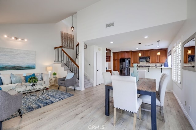 7712 Rockybrook Way, Stanton, CA 90680 - dining room featuring light wood finished floors, stairway, baseboards, recessed lighting, and high vaulted ceiling