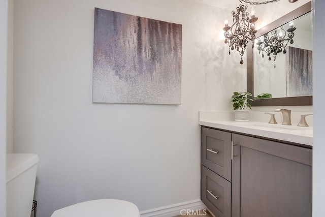 7712 Rockybrook Way, Stanton, CA 90680 - half bathroom featuring toilet, vanity, and a chandelier