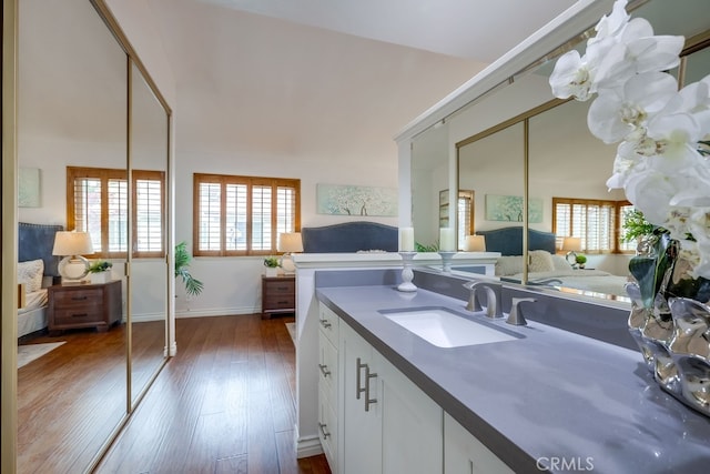 7712 Rockybrook Way, Stanton, CA 90680 - bathroom featuring vanity, hardwood / wood-style floors, and baseboards