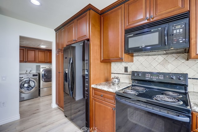7712 Rockybrook Way, Stanton, CA 90680 - kitchen with black appliances, separate washer and dryer, tasteful backsplash, light wood-style flooring, and brown cabinetry
