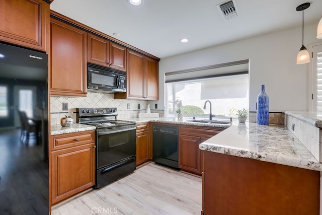 7712 Rockybrook Way, Stanton, CA 90680 - kitchen with black appliances, a sink, light wood-style flooring, tasteful backsplash, and brown cabinetry