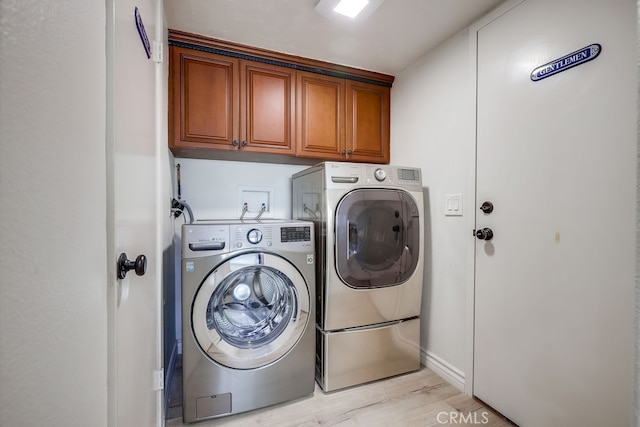 7712 Rockybrook Way, Stanton, CA 90680 - washroom with cabinet space, washer and dryer, light wood-style flooring, and baseboards
