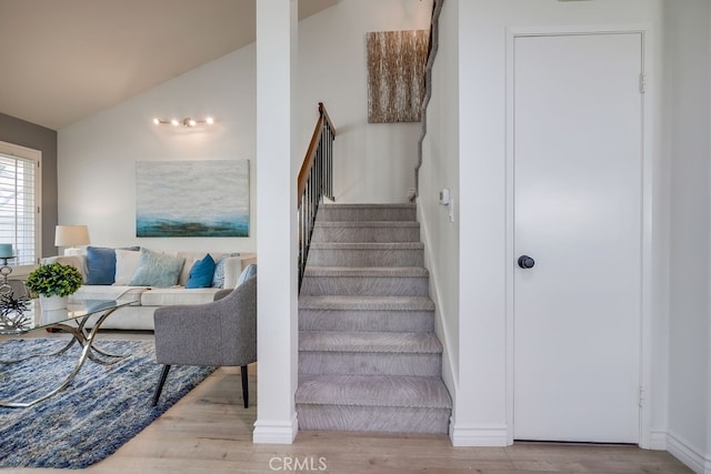 7712 Rockybrook Way, Stanton, CA 90680 - stairway featuring lofted ceiling, wood finished floors, and baseboards