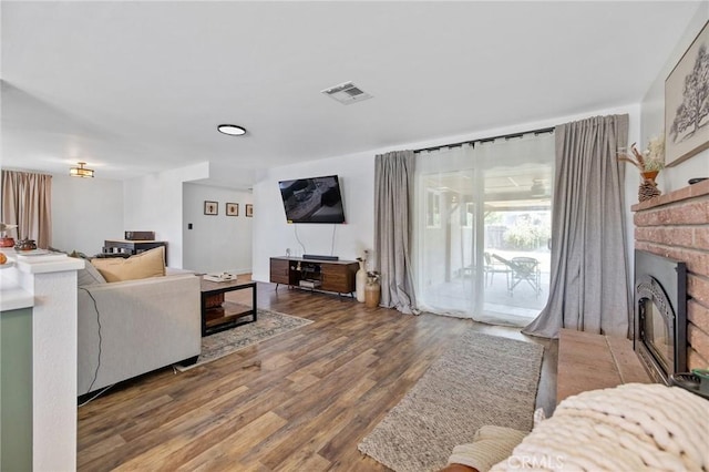 1505 Cypress Ln, Lemoore, CA 93245 - living room featuring wood finished floors and a fireplace
