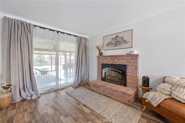 1505 Cypress Ln, Lemoore, CA 93245 - living area featuring a brick fireplace and wood finished floors