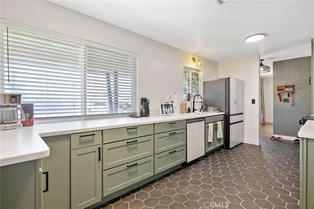 1505 Cypress Ln, Lemoore, CA 93245 - kitchen with green cabinetry, stainless steel appliances, light countertops, and a sink