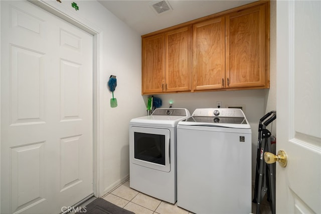 9552 Palm Dr, Desert Hot Springs, CA 92240 - laundry area featuring cabinet space, washer and dryer, and light tile patterned floors