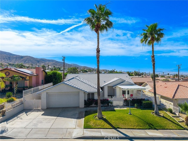 9552 Palm Dr, Desert Hot Springs, CA 92240 - ranch-style home featuring an attached garage, a mountain view, a tiled roof, driveway, and stucco siding