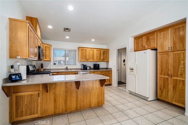 9552 Palm Dr, Desert Hot Springs, CA 92240 - kitchen with white fridge with ice dispenser, stove, a peninsula, a sink, and stainless steel microwave