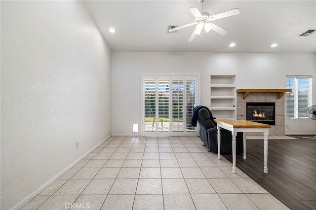 9552 Palm Dr, Desert Hot Springs, CA 92240 - living room featuring a tiled fireplace, built in shelves, recessed lighting, baseboards, and light tile patterned floors