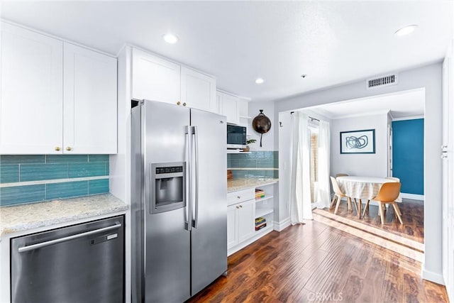 5847 E Rocking Horse Way Unit 21, Orange, CA 92869 - kitchen with stainless steel appliances, dark wood-type flooring, white cabinets, decorative backsplash, and baseboards