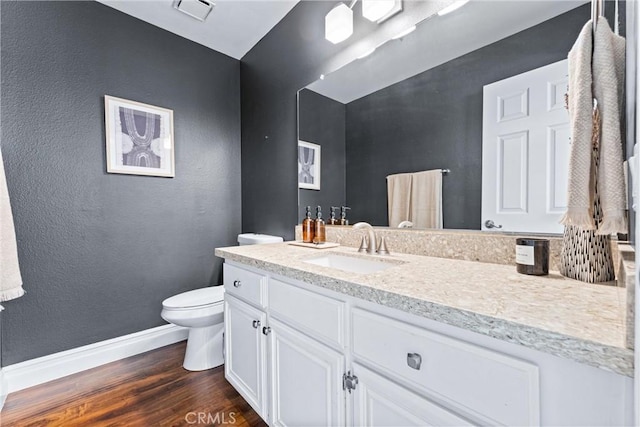 5847 E Rocking Horse Way Unit 21, Orange, CA 92869 - bathroom featuring wood finished floors, baseboards, vanity, toilet, and a textured wall