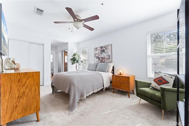 5847 E Rocking Horse Way Unit 21, Orange, CA 92869 - bedroom featuring light colored carpet, a ceiling fan, and multiple closets