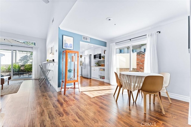 5847 E Rocking Horse Way Unit 21, Orange, CA 92869 - dining room featuring ornamental molding, wood finished floors, and baseboards
