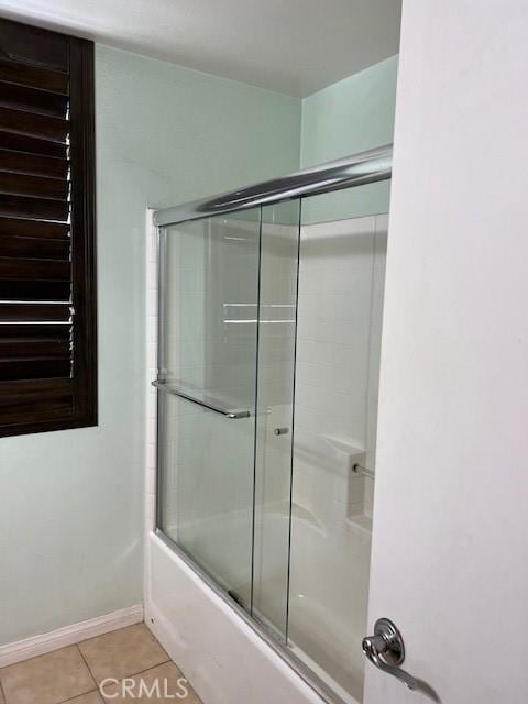 16089 Gables Loop, Whittier, CA 90603 - bathroom featuring bath / shower combo with glass door, tile patterned floors, and baseboards