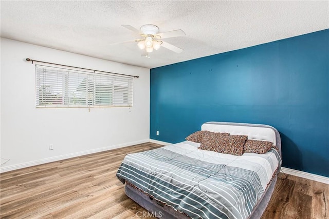 1210 3rd St, Calimesa, CA 92320 - bedroom with a textured ceiling, wood finished floors, and ceiling fan