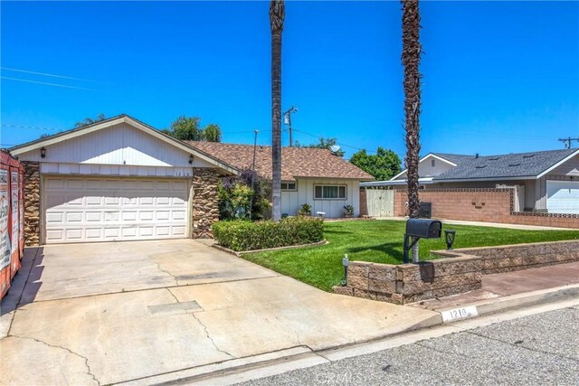 1210 3rd St, Calimesa, CA 92320 - single story home with driveway, an attached garage, and stone siding