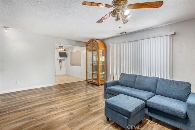1210 3rd St, Calimesa, CA 92320 - living room with a ceiling fan, wood finished floors, and a textured ceiling