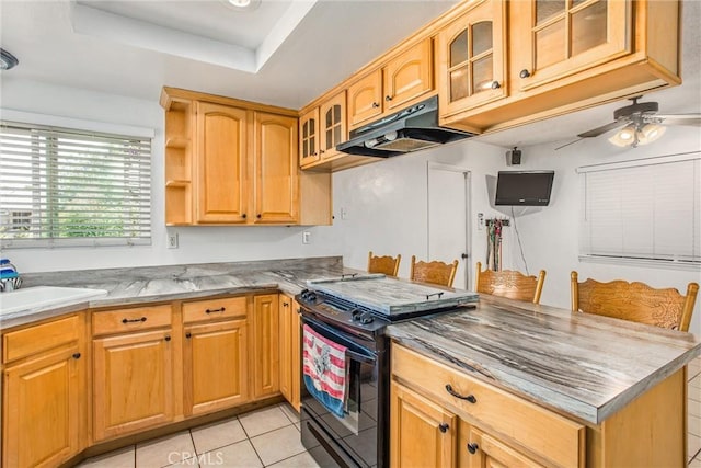 1210 3rd St, Calimesa, CA 92320 - kitchen featuring black range oven, ceiling fan, under cabinet range hood, a peninsula, and light tile patterned flooring