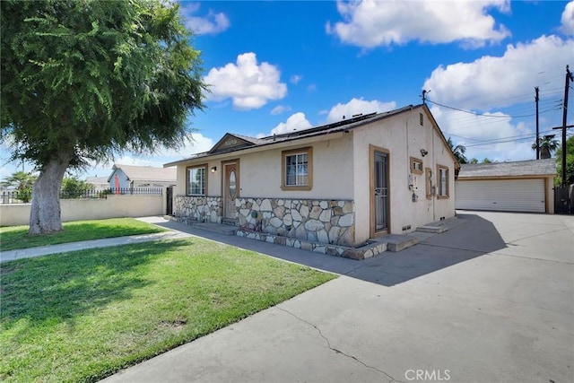 3879 Big Dalton Ave, Baldwin Park, CA 91706 - view of front of house featuring stucco siding, solar panels, stone siding, an outbuilding, and a garage
