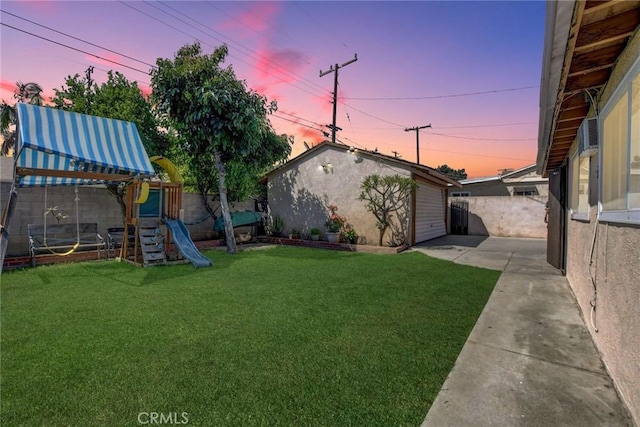 3879 Big Dalton Ave, Baldwin Park, CA 91706 - yard at dusk featuring a playground and a patio area