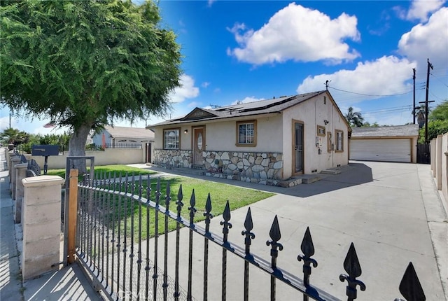 3879 Big Dalton Ave, Baldwin Park, CA 91706 - view of front of property with stucco siding, solar panels, stone siding, an outbuilding, and a garage