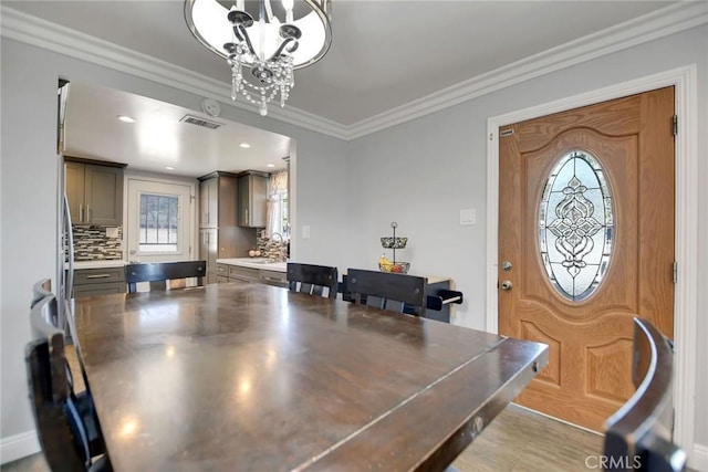 3879 Big Dalton Ave, Baldwin Park, CA 91706 - dining space featuring plenty of natural light, a chandelier, and ornamental molding