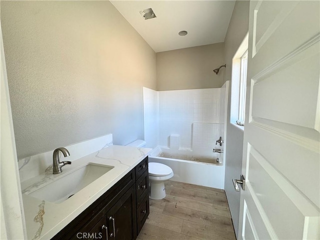 14549 Live Oak St, Hesperia, CA 92345 - bathroom featuring toilet, vanity, wood finished floors, and  shower combination