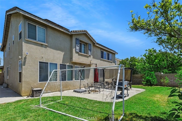 15691 Cherry Leaf Ln, Fontana, CA 92336 - back of property featuring stucco siding, a patio area, and cooling unit