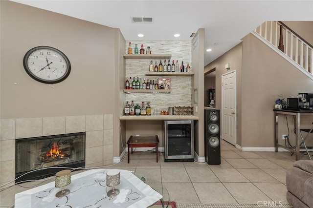15691 Cherry Leaf Ln, Fontana, CA 92336 - indoor dry bar with beverage cooler, light tile patterned floors, a fireplace, and baseboards