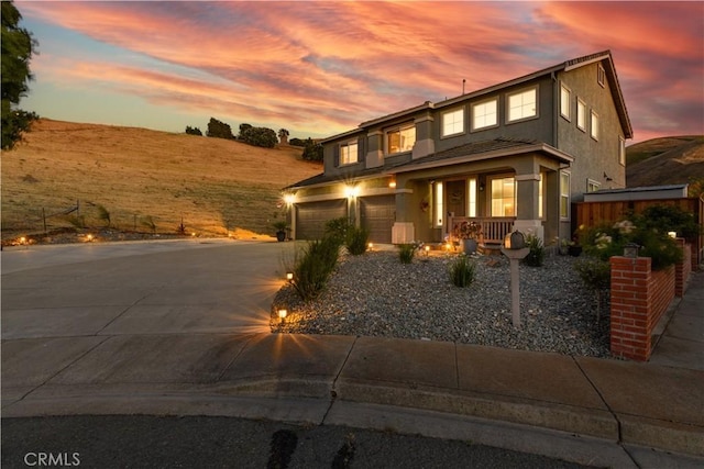 21 Fawn Glen Ct, Pittsburg, CA 94565 - view of front of home with an attached garage, concrete driveway, stucco siding, and a porch